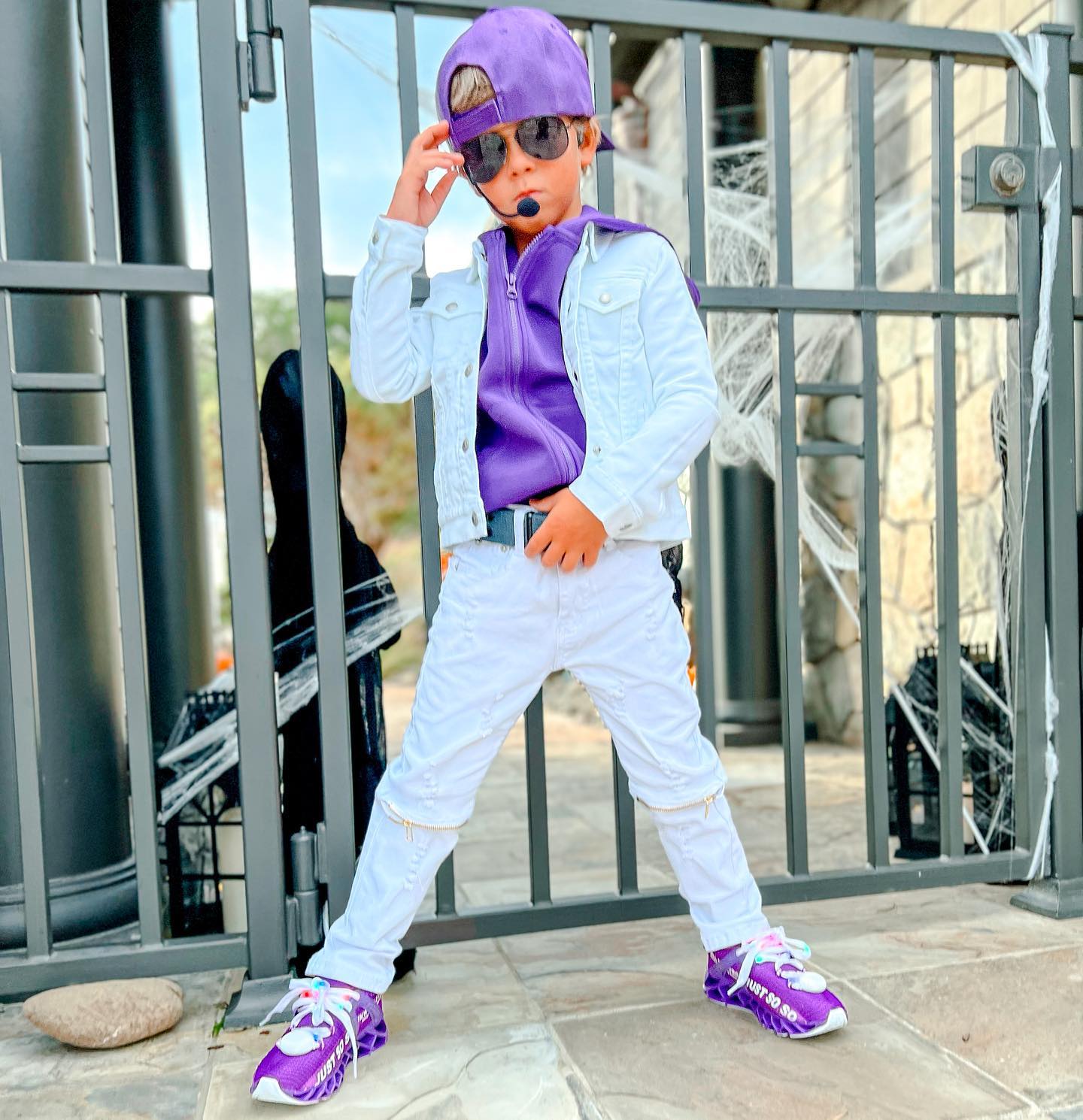 Young creator Tydus Talbott smiling with his family, representing a childhood spent in front of the camera and shaped by supportive parenting.