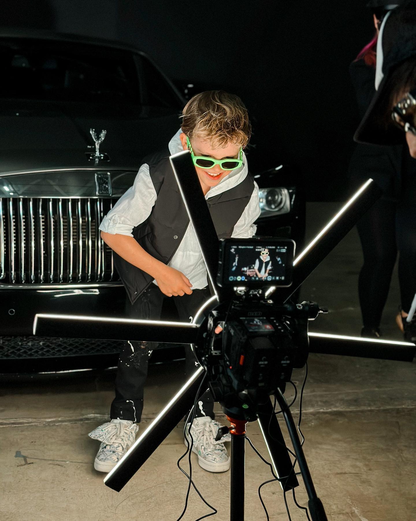 Young creator Tydus Talbott smiling with his family, representing a childhood spent in front of the camera and shaped by supportive parenting.